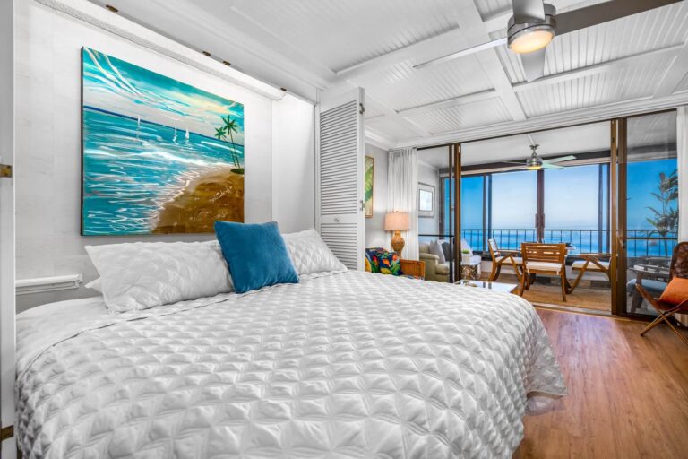 The bedroom and patio of a vacation rental in Hawaii.